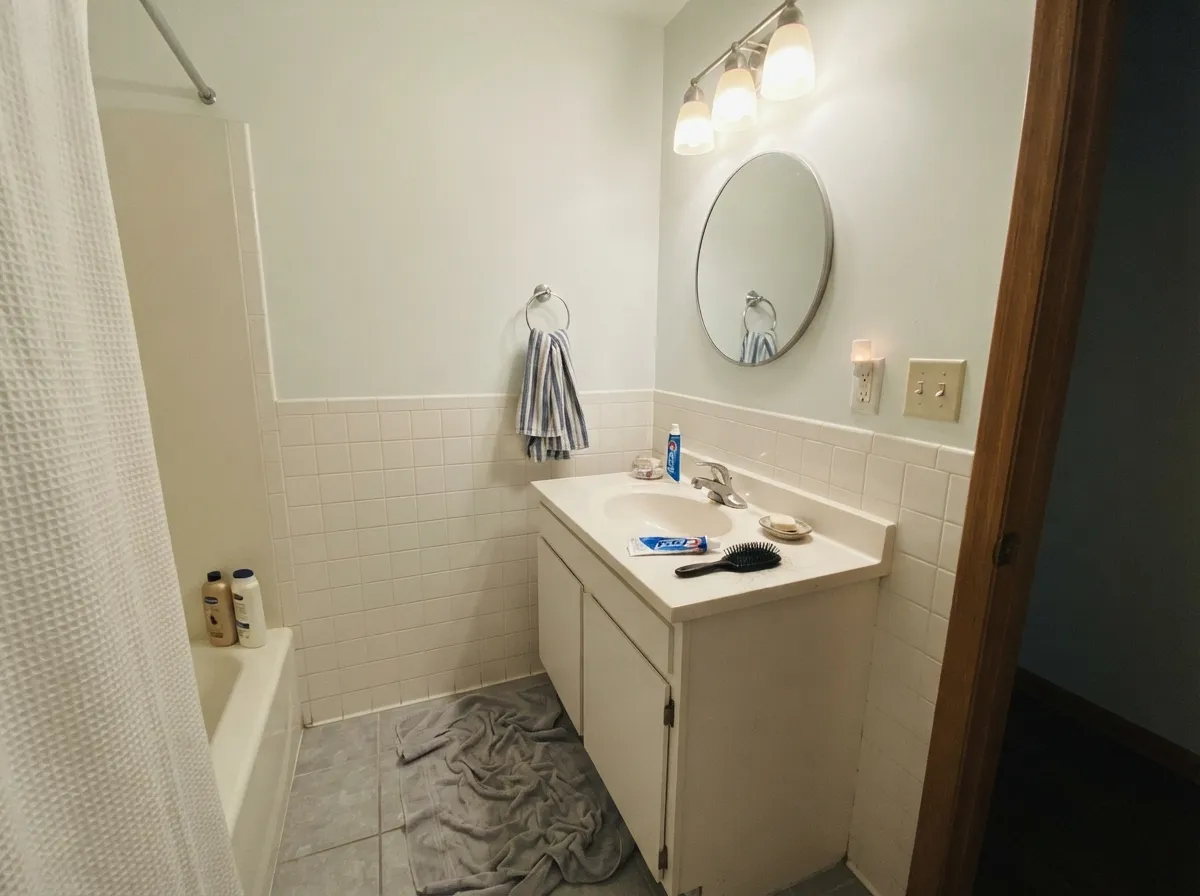 In a bathroom the cool cast is simply correct — it agrees with white tile and chrome and makes a windowless room read clean rather than dim.