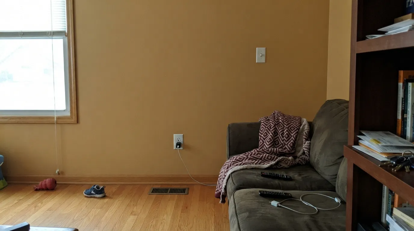 The honest shot: wall-to-wall honey oak plus overcast light and no lamps — the walls stop reading as a color choice and start reading as one flat golden-brown box.