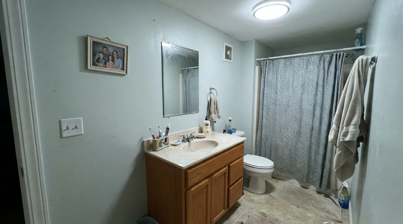 The honest shot: cool LEDs and a honey-oak vanity together — the exact predictable combination this color's fails section warns about.