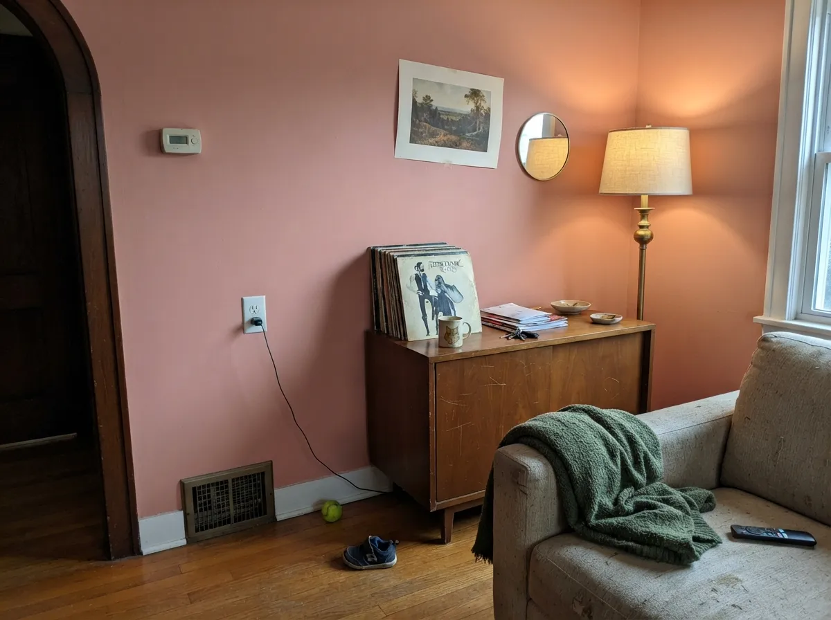 As a single accent wall with walnut furniture and brass, it reads as a confident mid-century choice, not a pink phase.
