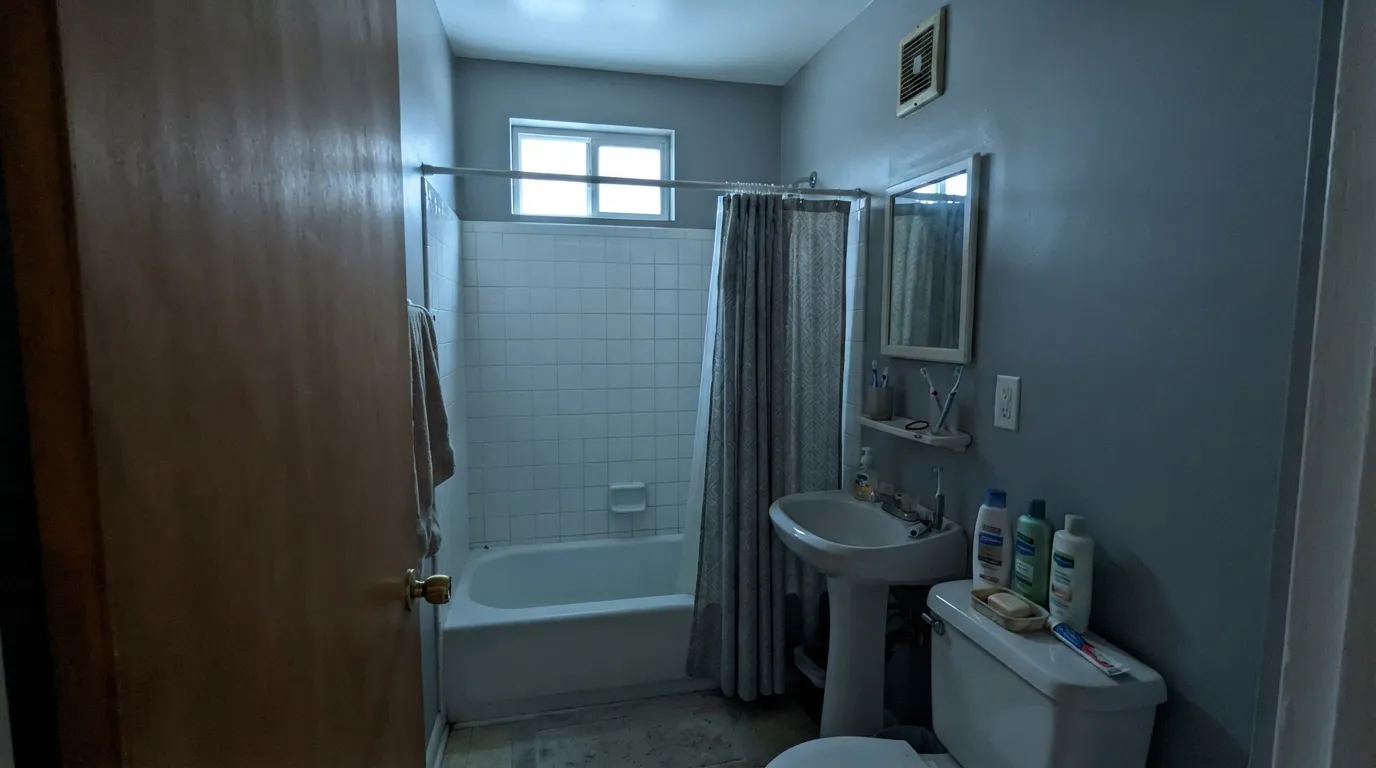 The honest shot: cool north light strips the blue and leaves a dirty gray — the dim-room version of this color.