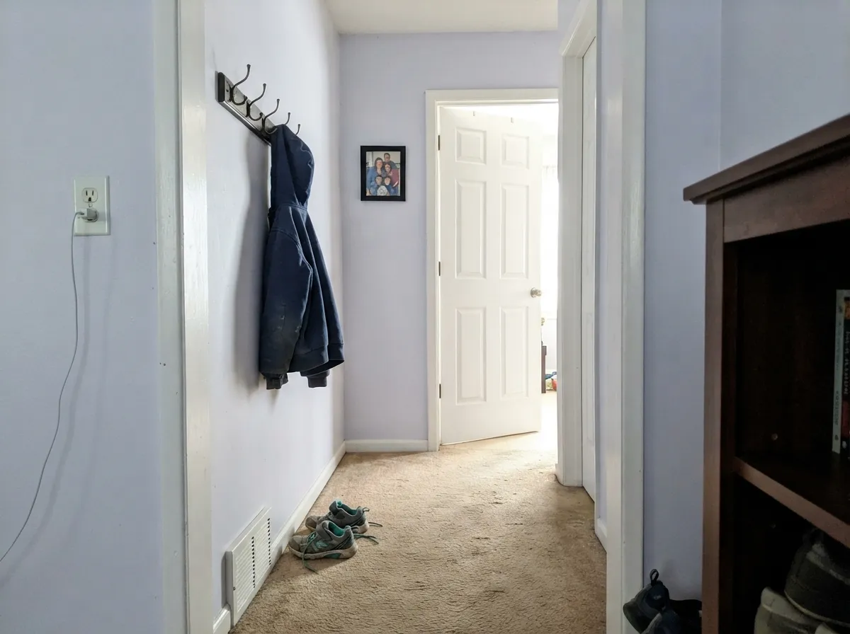 Close enough to white to run a hallway without becoming its own decision, with just enough cool tint to feel less clinical than a true white.