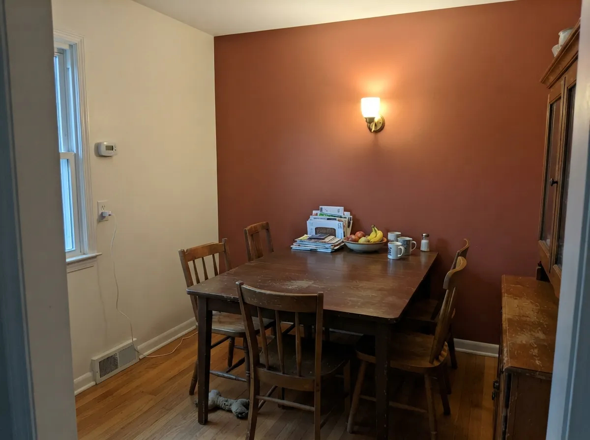 As a dining-room accent wall with walnut and warm lamp light, the clay reads grounded and rich, not overwhelming.