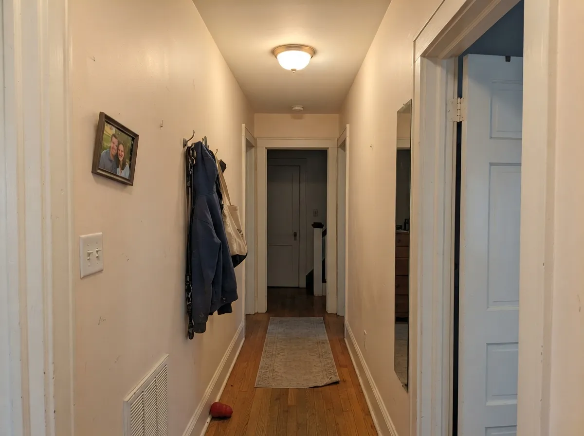In a hallway with no daylight it stays warm instead of going blue-white — the job this color has quietly done for decades.
