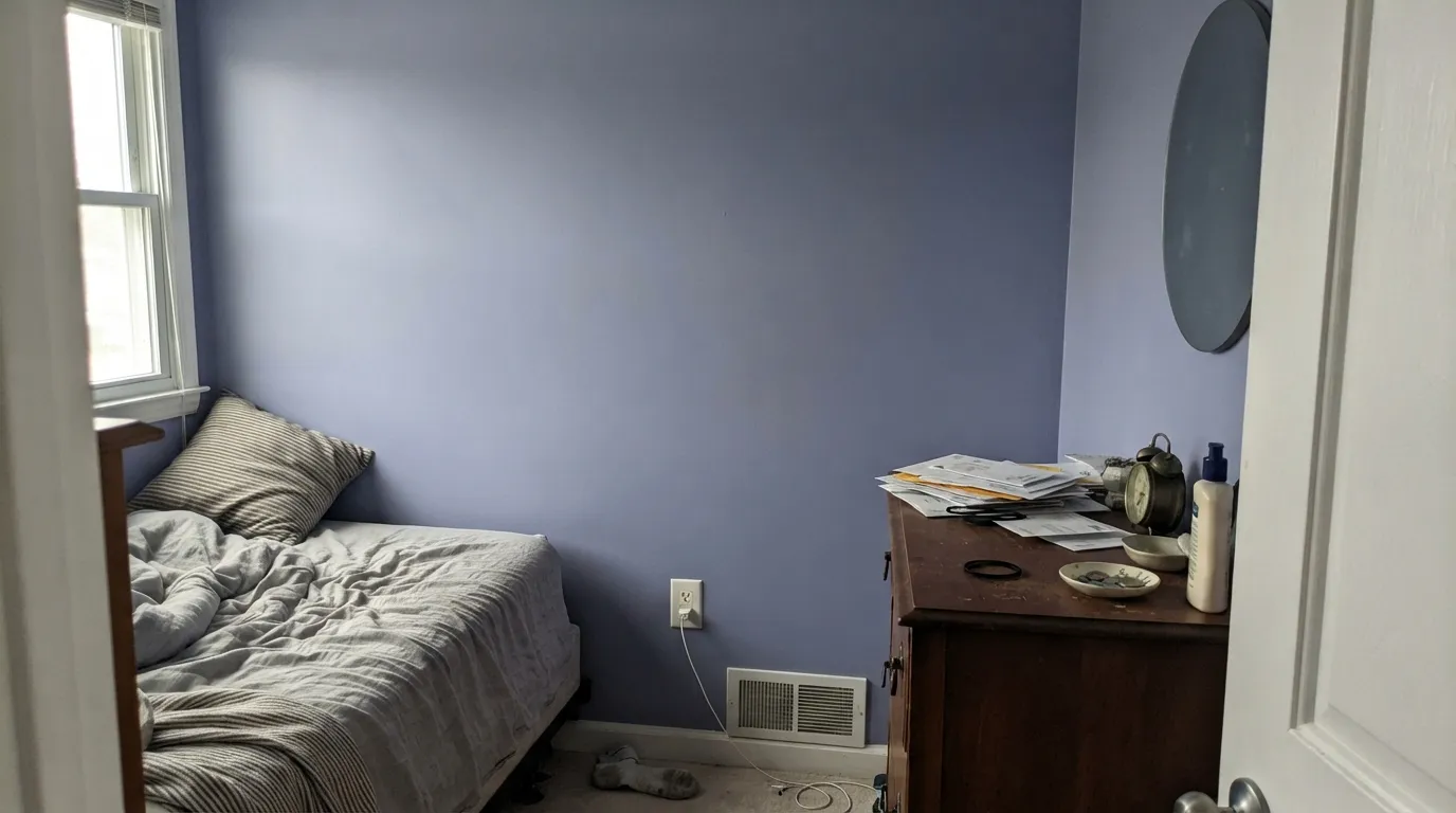 The honest shot: cool, overcast north light pulls the violet forward and the wall goes hazy lilac instead of the clean blue the chip promised.