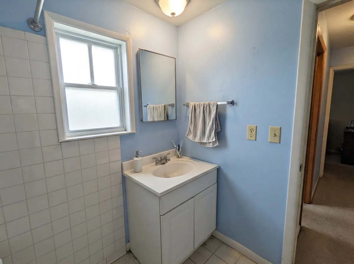 In a daylit bath it reads fresh and spa-like against white tile and chrome — the second room it never fails in.