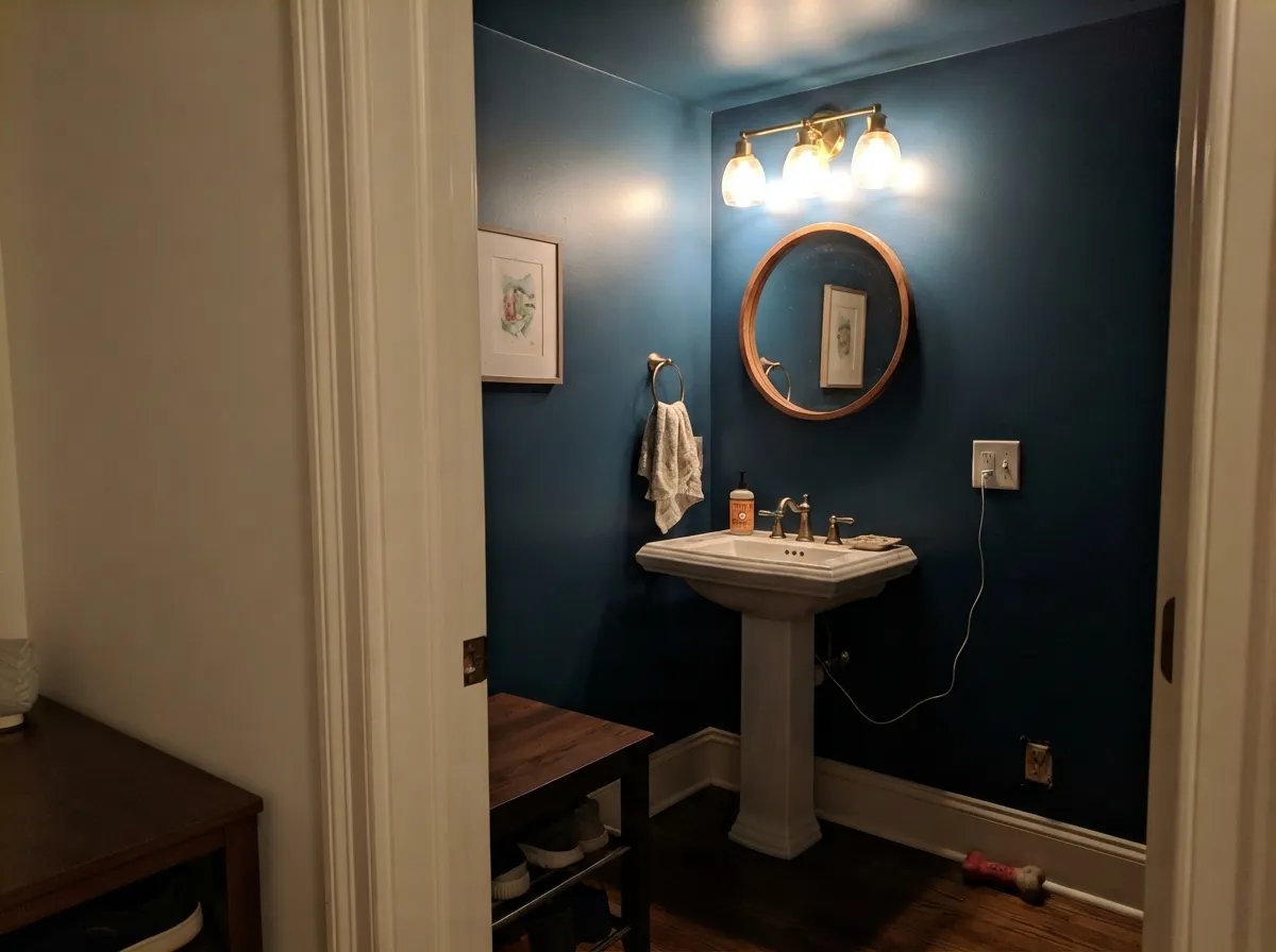 Drenched top to bottom in a powder room — the one place four walls of this blue is the right call.