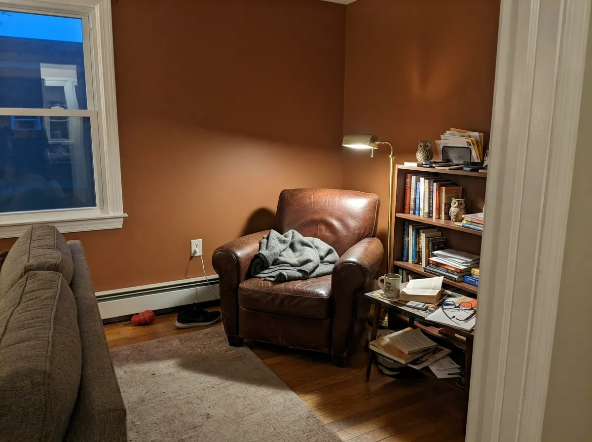 In a lamplit den with leather and walnut, the depth becomes the whole point — cozy, not cave-like.
