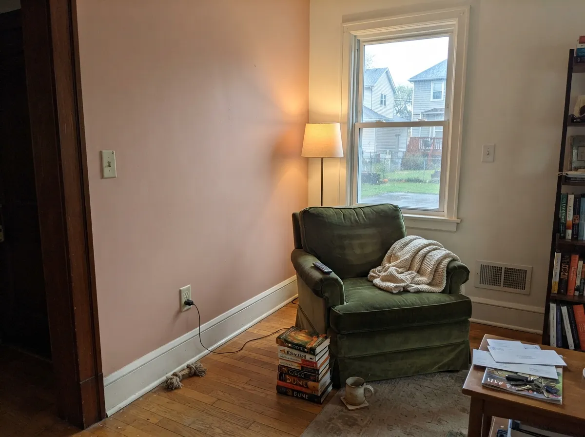 Against warm wood and cream textiles, the sepia-pink reads calm and grown-up, not childish.