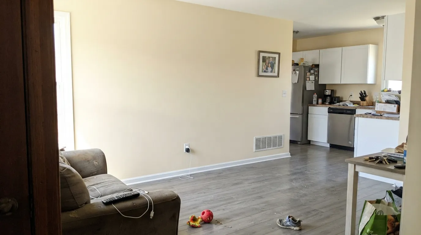 The honest shot: midday sun plus bright white cabinets, and Cream stops being cream — the wall goes yellow and looks aged next to the doors.