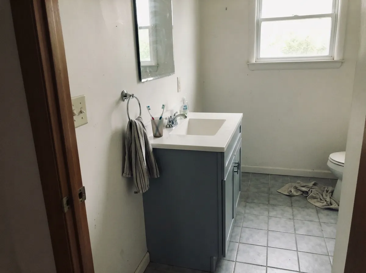 On a vanity in satin, under a white top with chrome, it looks specified rather than picked — white porcelain is its natural company.