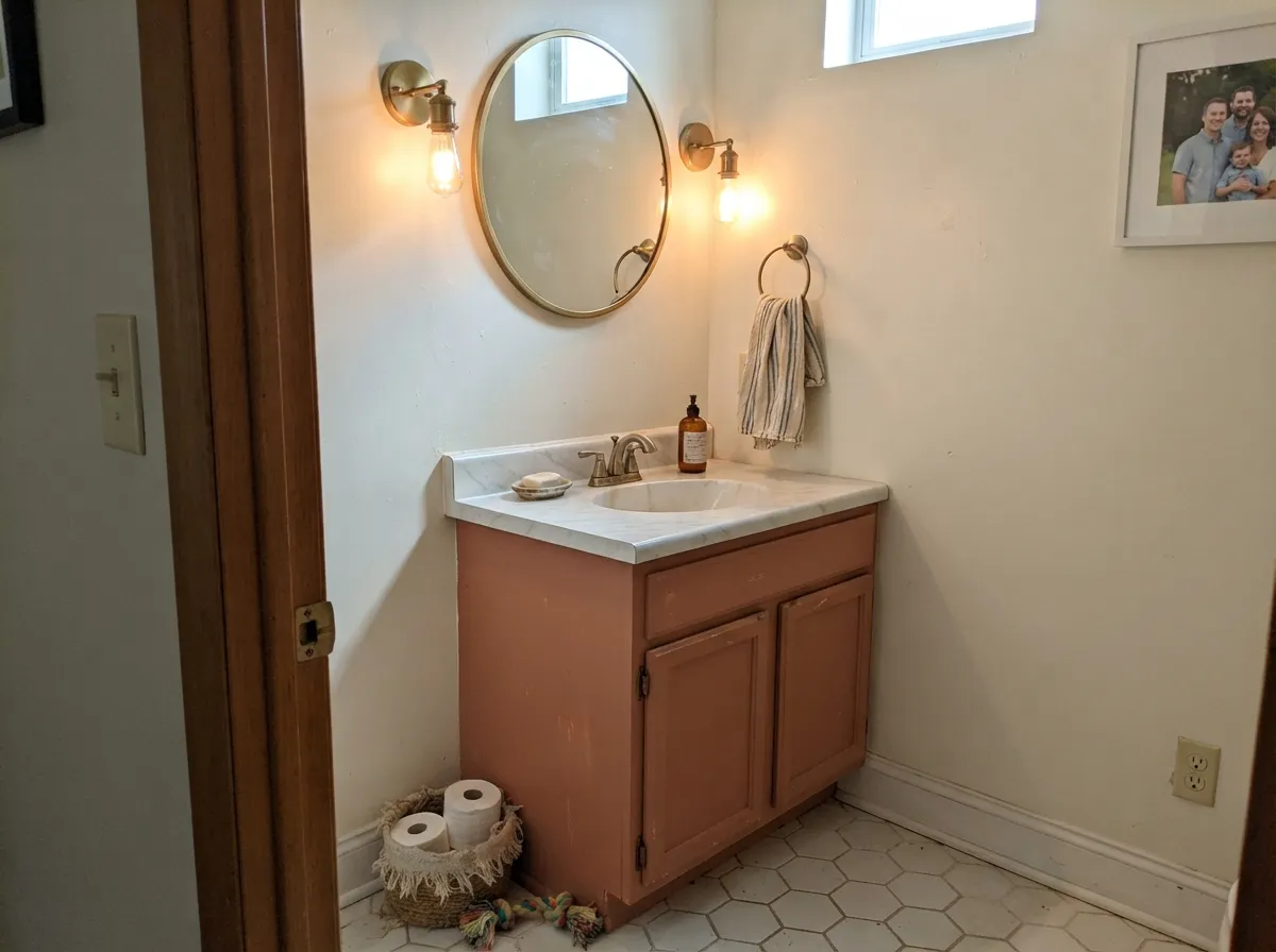 The designer move: a terracotta vanity under warm cream walls — enough color to feel intentional, small enough to be a weekend project.
