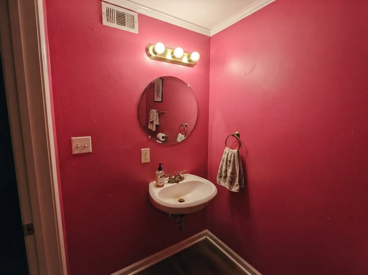 Drenched in a small powder room the color reads deliberate and expensive — five minutes of occupancy is exactly the right dose.