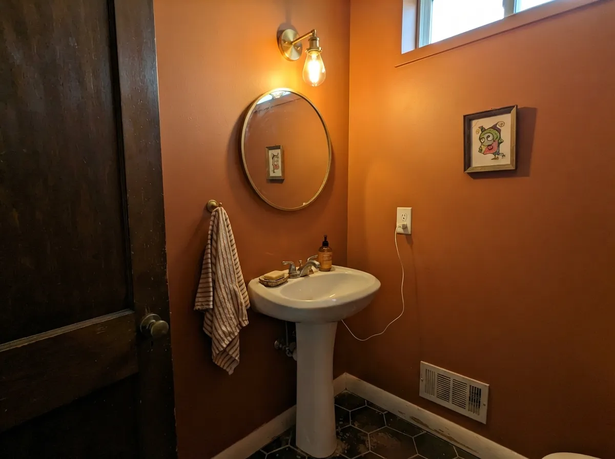 Drenched in a small powder room, the color reads custom, not risky — there's no big open wall for it to overwhelm.