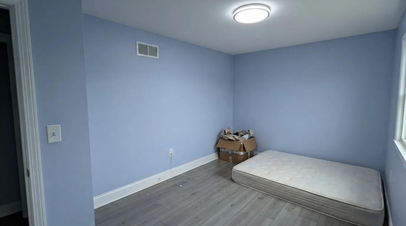 The honest shot: north light, cool LEDs, stark white trim and gray floors strip the warmth out and leave the steely, hospital-corridor blue that most bad reviews describe.
