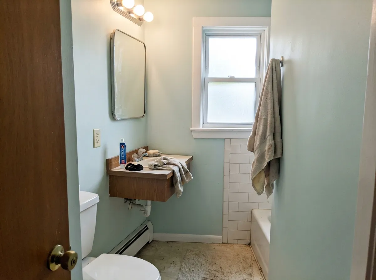 The spa-bath job: white tile and a real window let Headspace read teal-calm instead of mint candy.