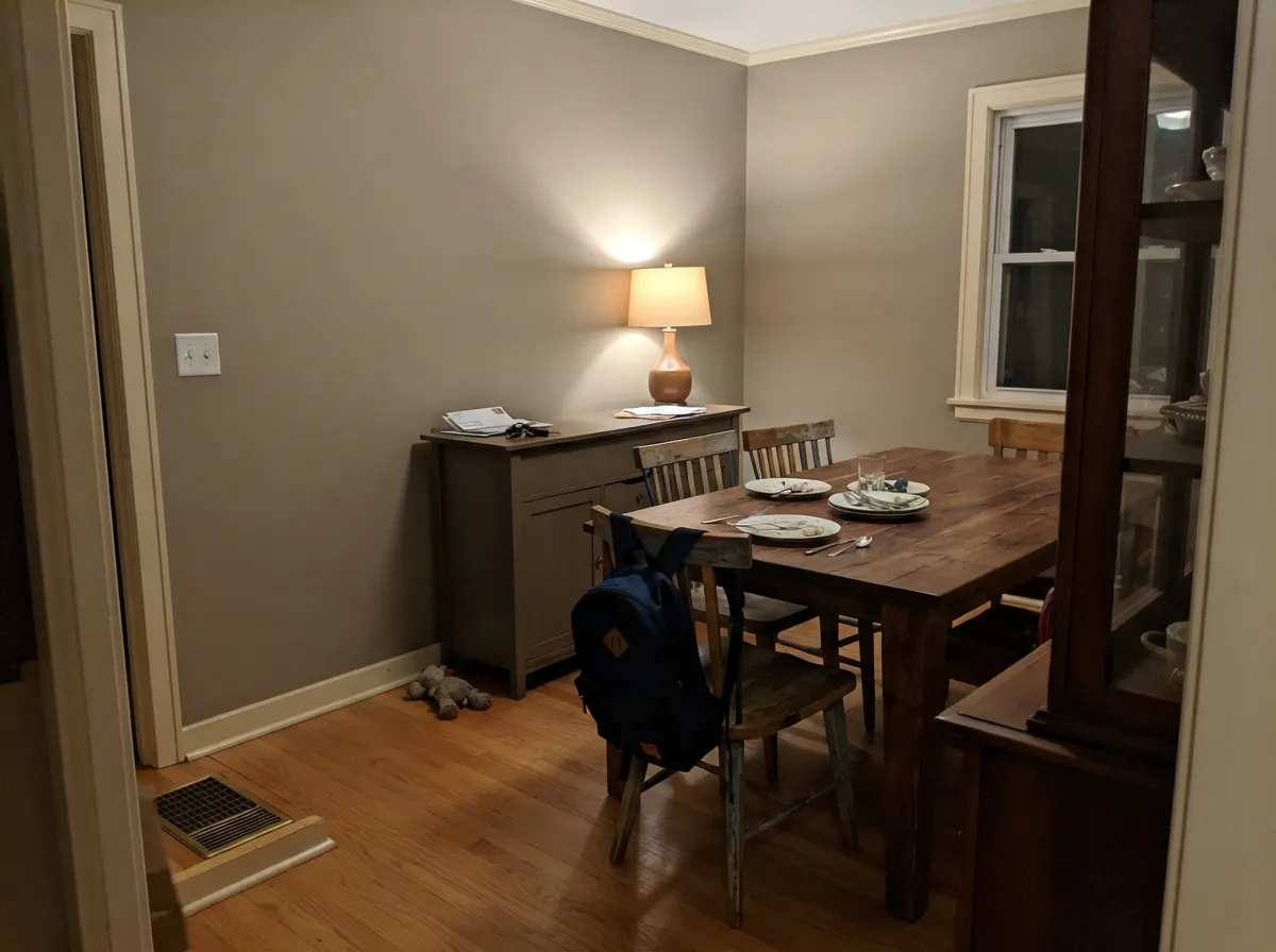 After dark the yellow-brown comes forward — a dining room that should feel grounded, not gray.