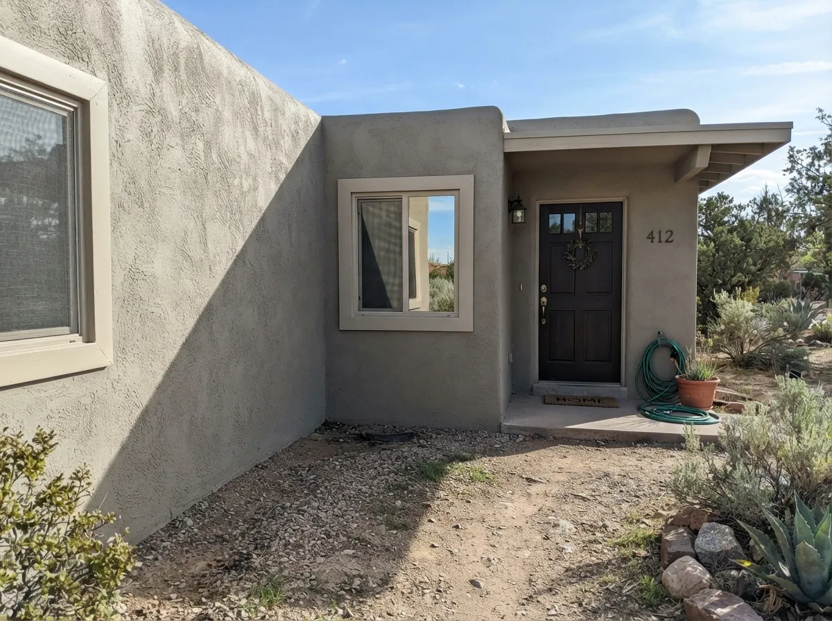 The real job: on stucco in Western sun Wooden Peg holds as warm sand-greige instead of washing out — Light Beige trim, espresso door.