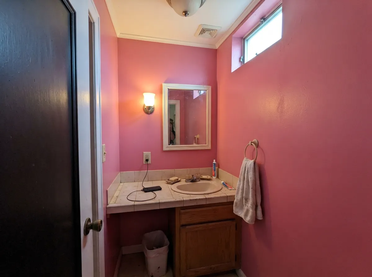 A powder-room drench is the one full-room yes — small, lamplit, and clearly a decision.