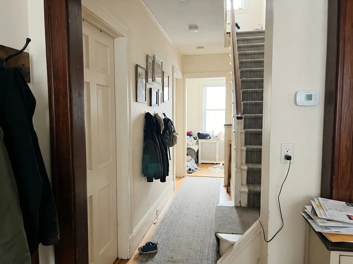 The north-hall test: Pointing stays a finished off-white in cool borrowed light instead of going dingy grey — the red-cream doing the job it was mixed for.