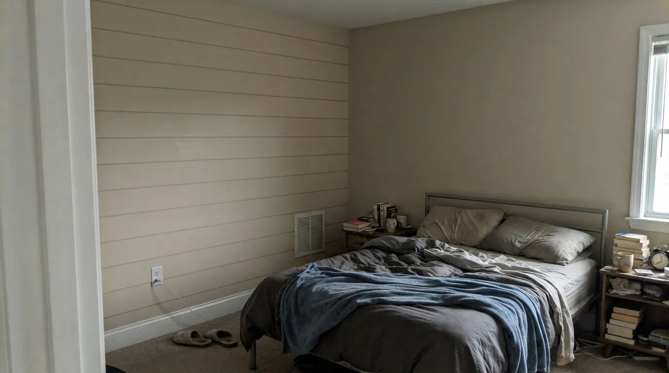 The honest shot: dim north light with no warm lamp drains the cream out, and the brighter door trim makes the wall look dingy — the exact combination behind the mixed "warm" versus "gray" owner reviews.