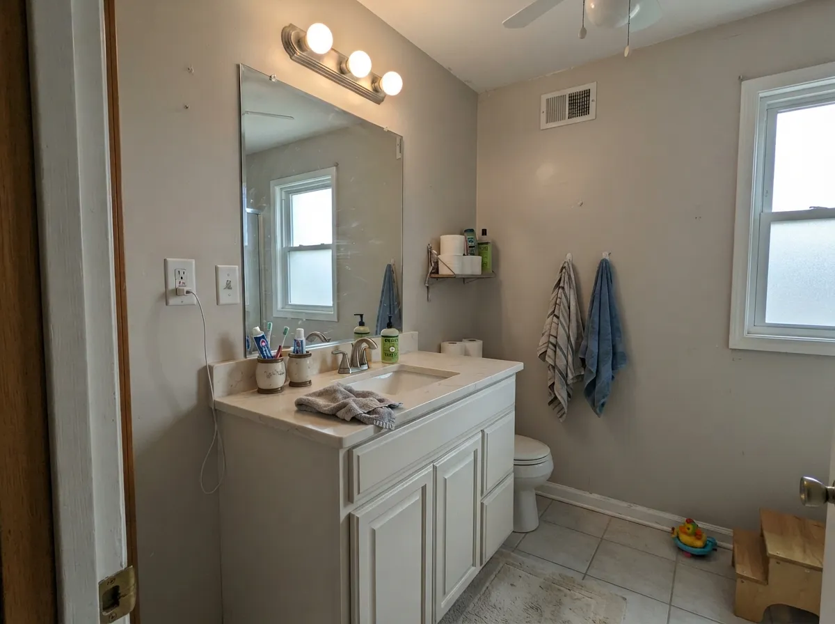 In a bathroom with cream stone it stays soft — no clinical edge.