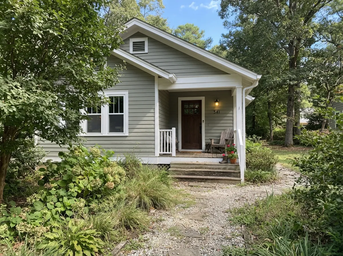 Clary Sage exterior siding blending into the trees with white trim.