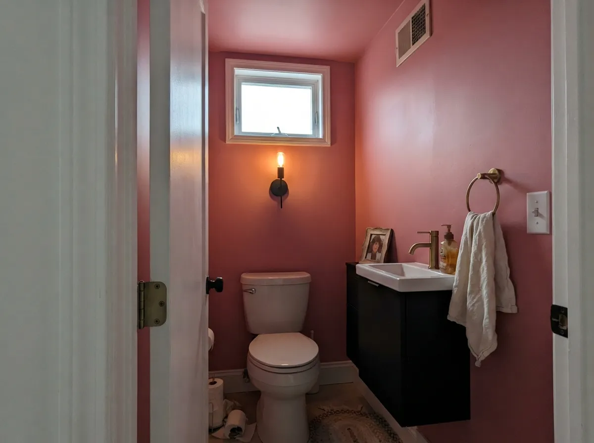 Drenched: walls and ceiling in one color is the way this saturation reads intentional — a black vanity and crisp white trim do the rest.