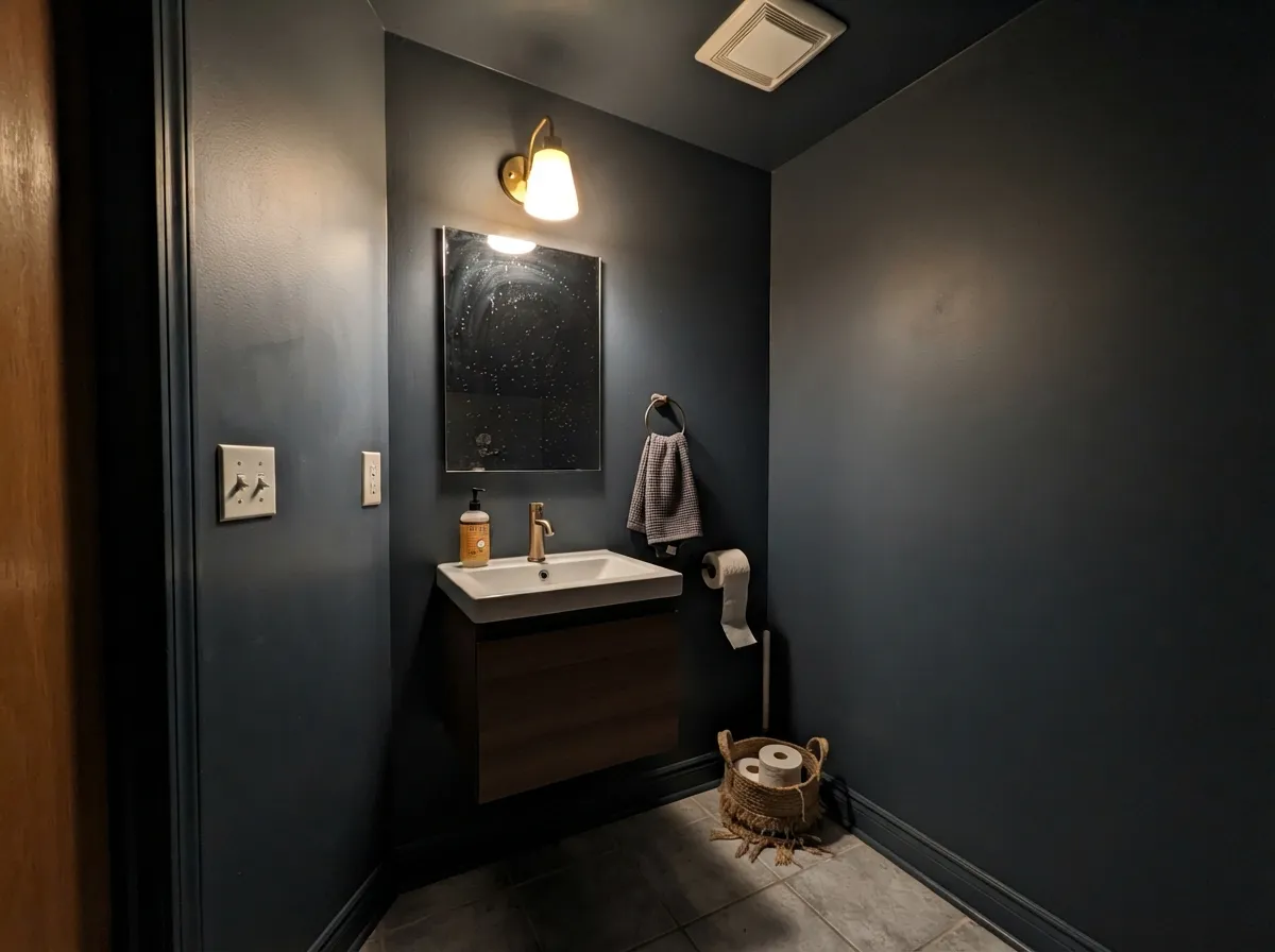 Painted wall-to-ceiling under one warm bulb, the darkness stops being a problem and becomes the point.
