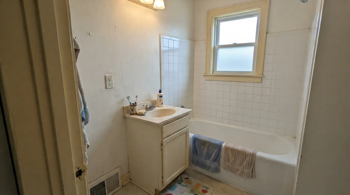 The honest shot: butted against a bright white tub and white tile, Dover White stops looking creamy and starts looking dirty — the exact complaint behind most of the regret.