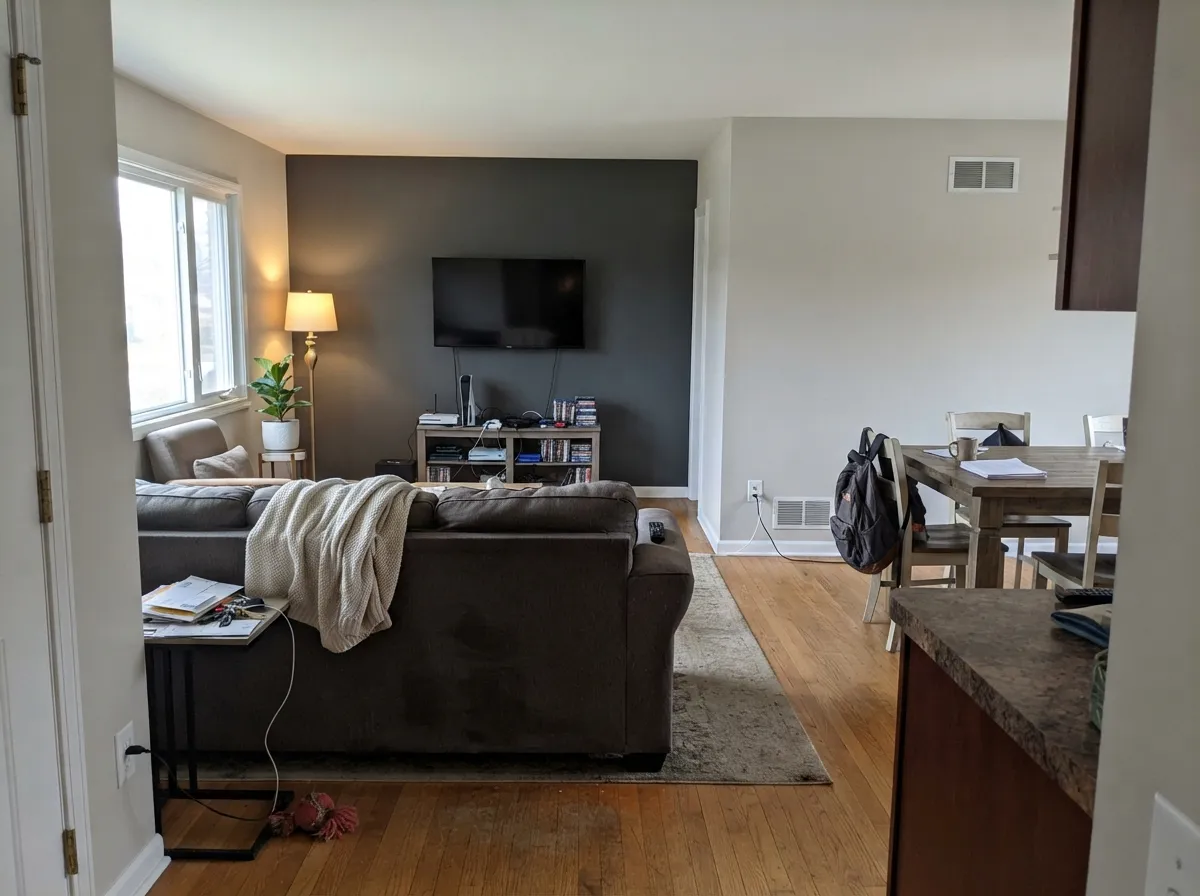 Drift of Mist carried across open-plan living and dining walls with a dark accent wall.