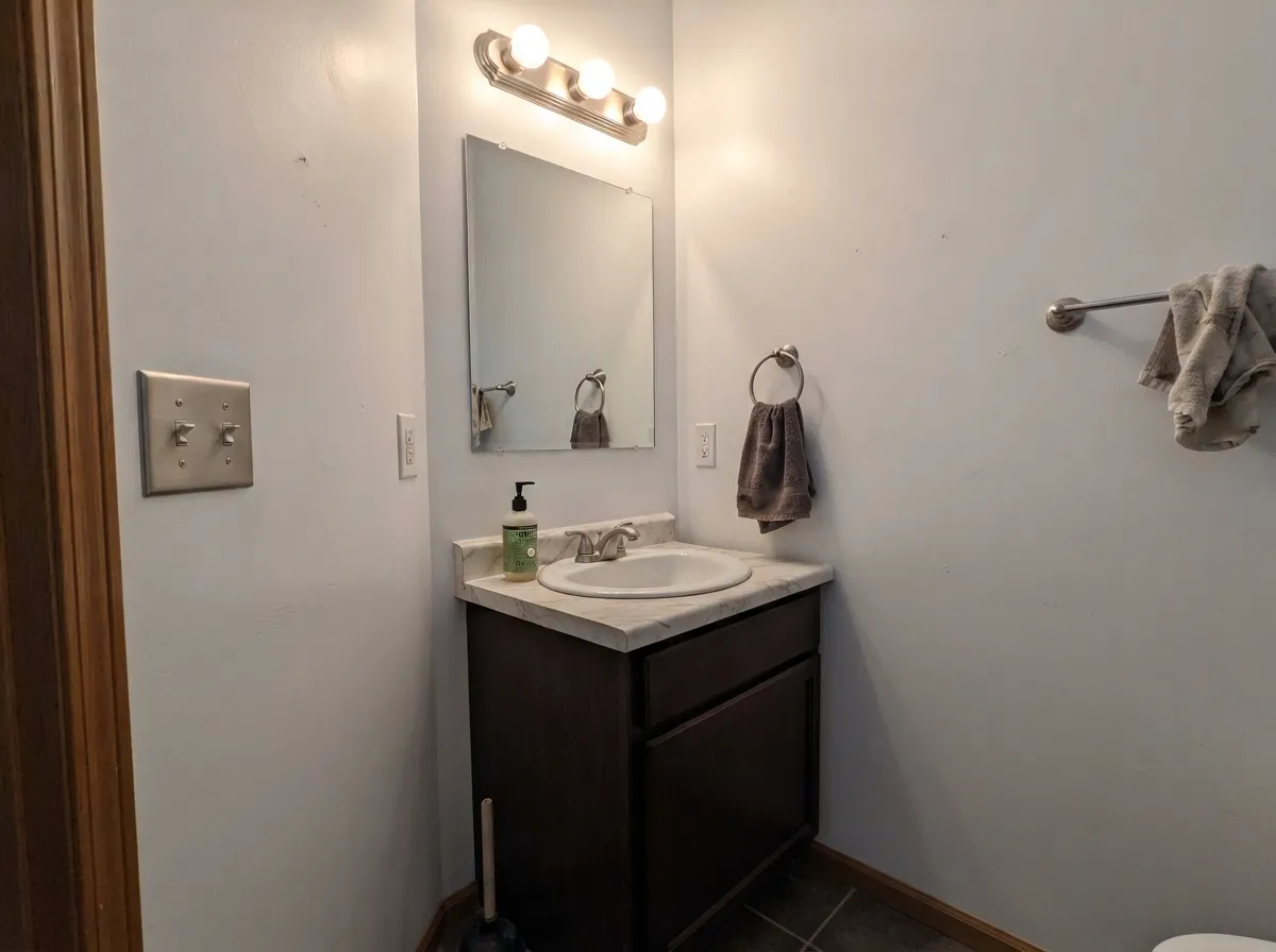 With no window at all, the high reflectance does the work daylight cannot — the room reads bigger than it is.