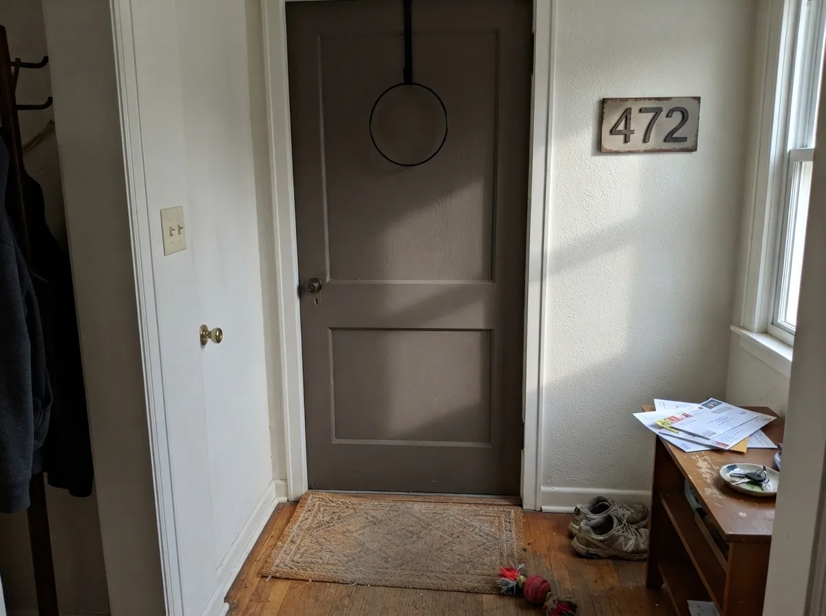 A near-black door is the move — it grounds the warm siding instead of fighting it.