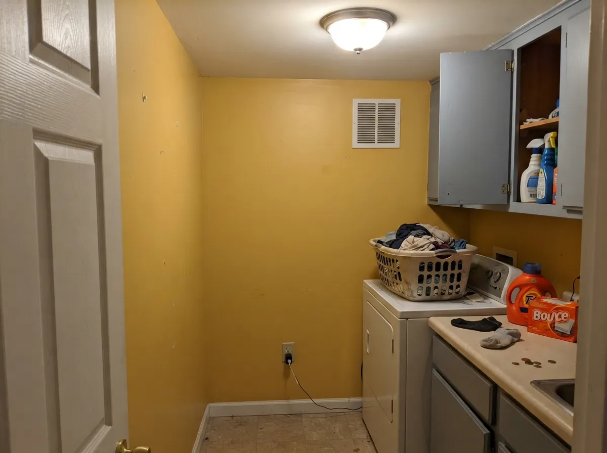 No window at all, and it still reads sunny — the cool gray cabinets are what keep the yellow crisp instead of syrupy.