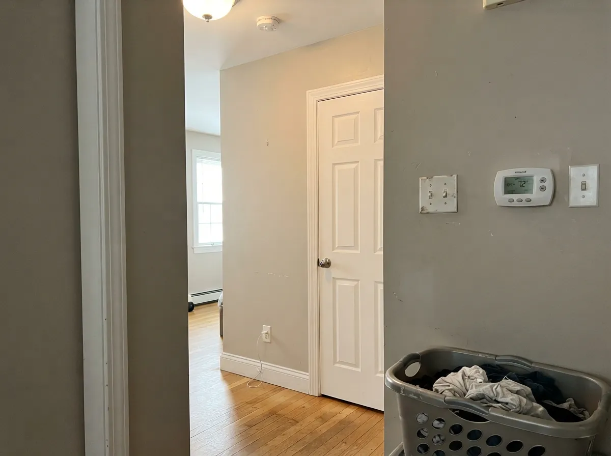 Over warm greige walls the trim frames the color instead of cutting it — no cold blue line around the casings.