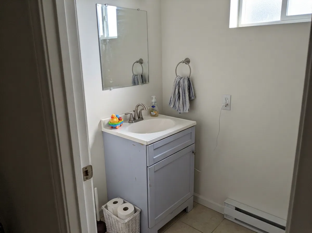 Its designer move: a lilac vanity under white walls, close enough to actually read as purple.