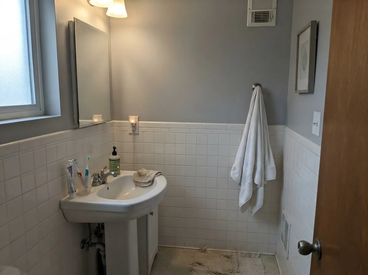 With a window and white tile it reads crisp and spa-like - in a windowless version of this room it would need to be cut to half strength.