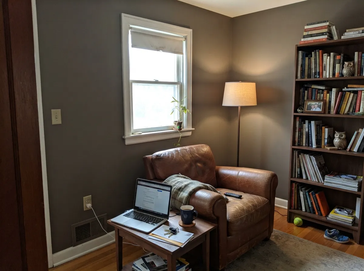With real daylight and leather and walnut, the brown underneath comes forward and the room feels grounded, not dim.