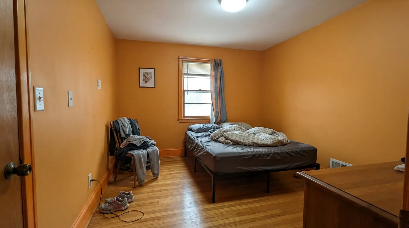 The honest shot: four walls of it in a dim, cool-lit room over honey oak — the gold turns muddy, the ceiling picks up the cast, and nothing in the room pushes back.