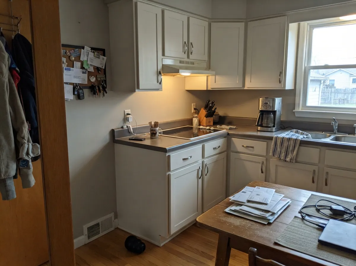 The quieter alternative to Alabaster: Toque White cabinets against Agreeable Gray walls, a shade calmer than a bright white kitchen.