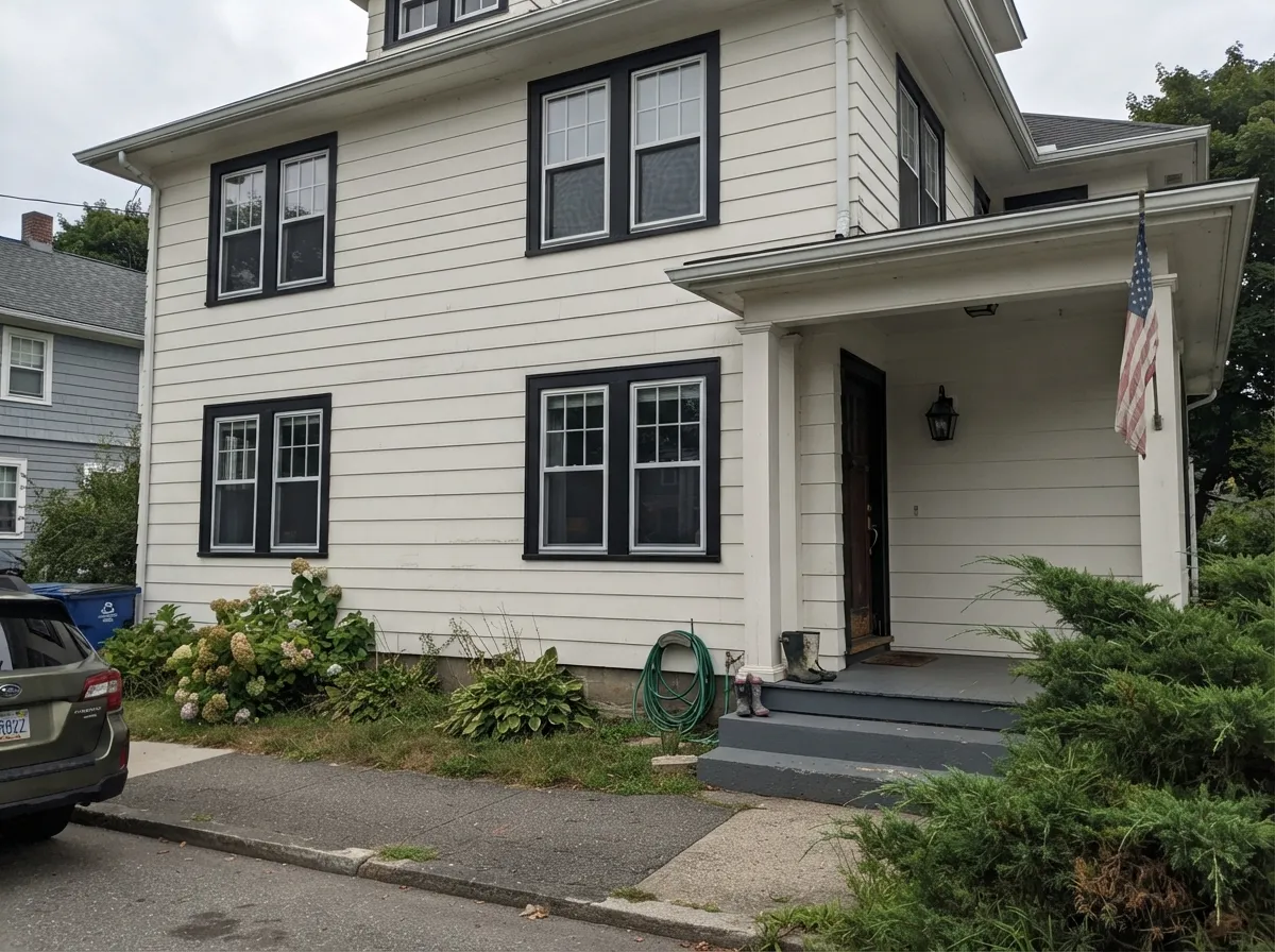 Tricorn Black window sash trim against white siding.