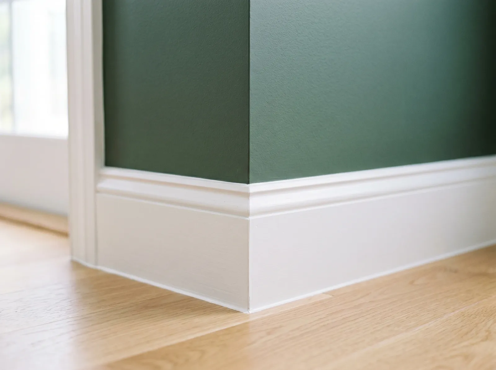Finished wall-to-trim corner with a crisp sharp paint line after repair