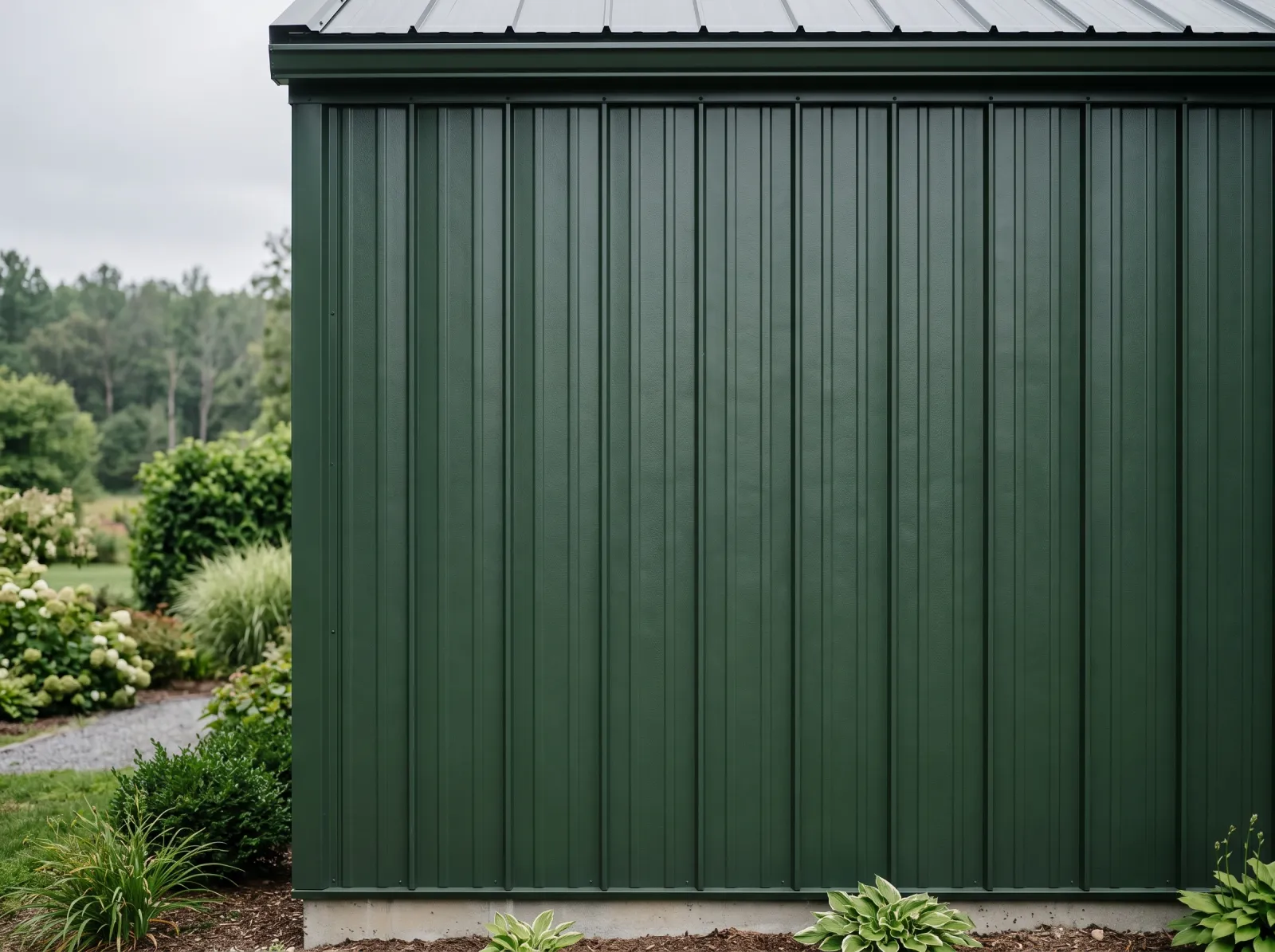 Finished plastisol metal siding painted even dark green with texture visible