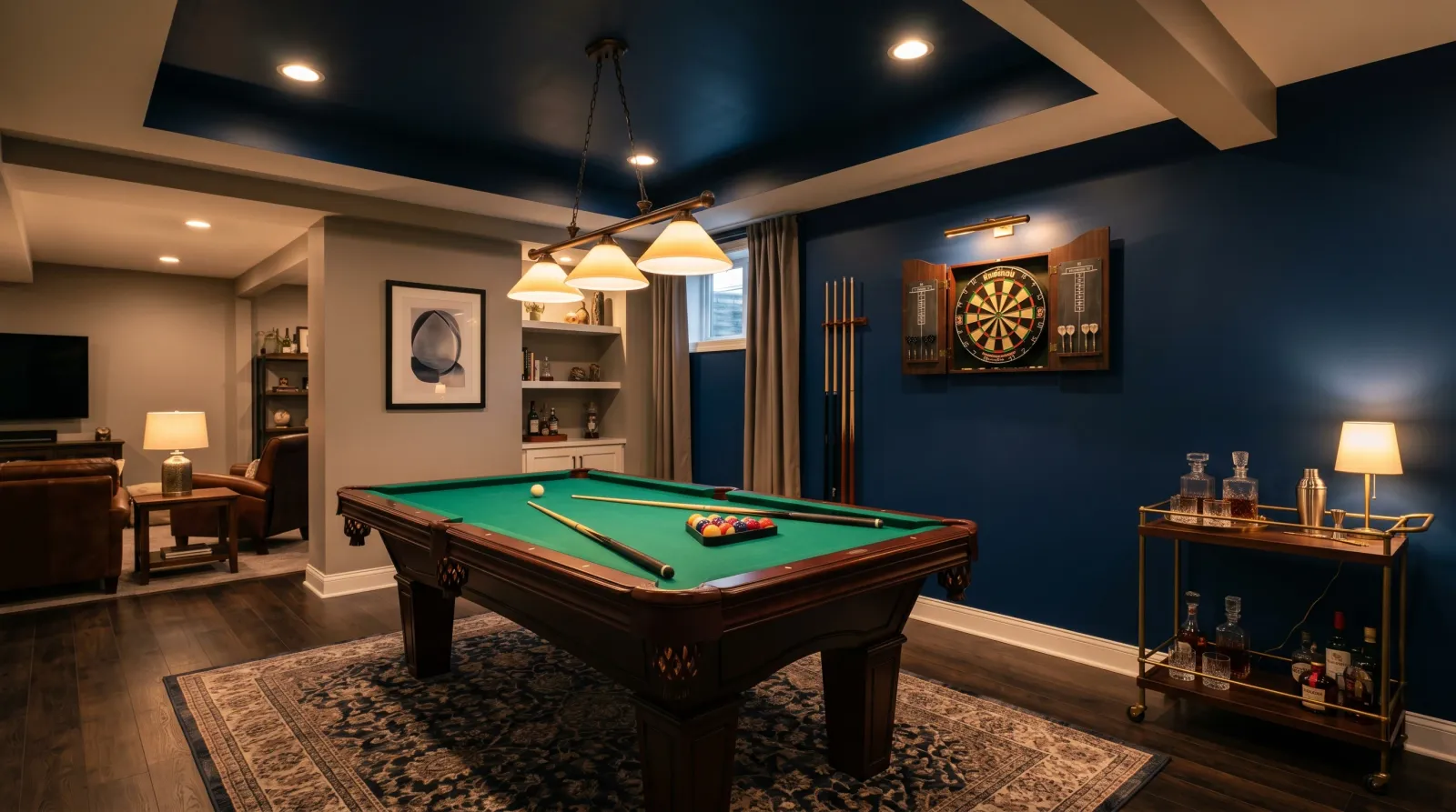 Finished basement game room with navy accent wall, pool table, and dartboard back in place