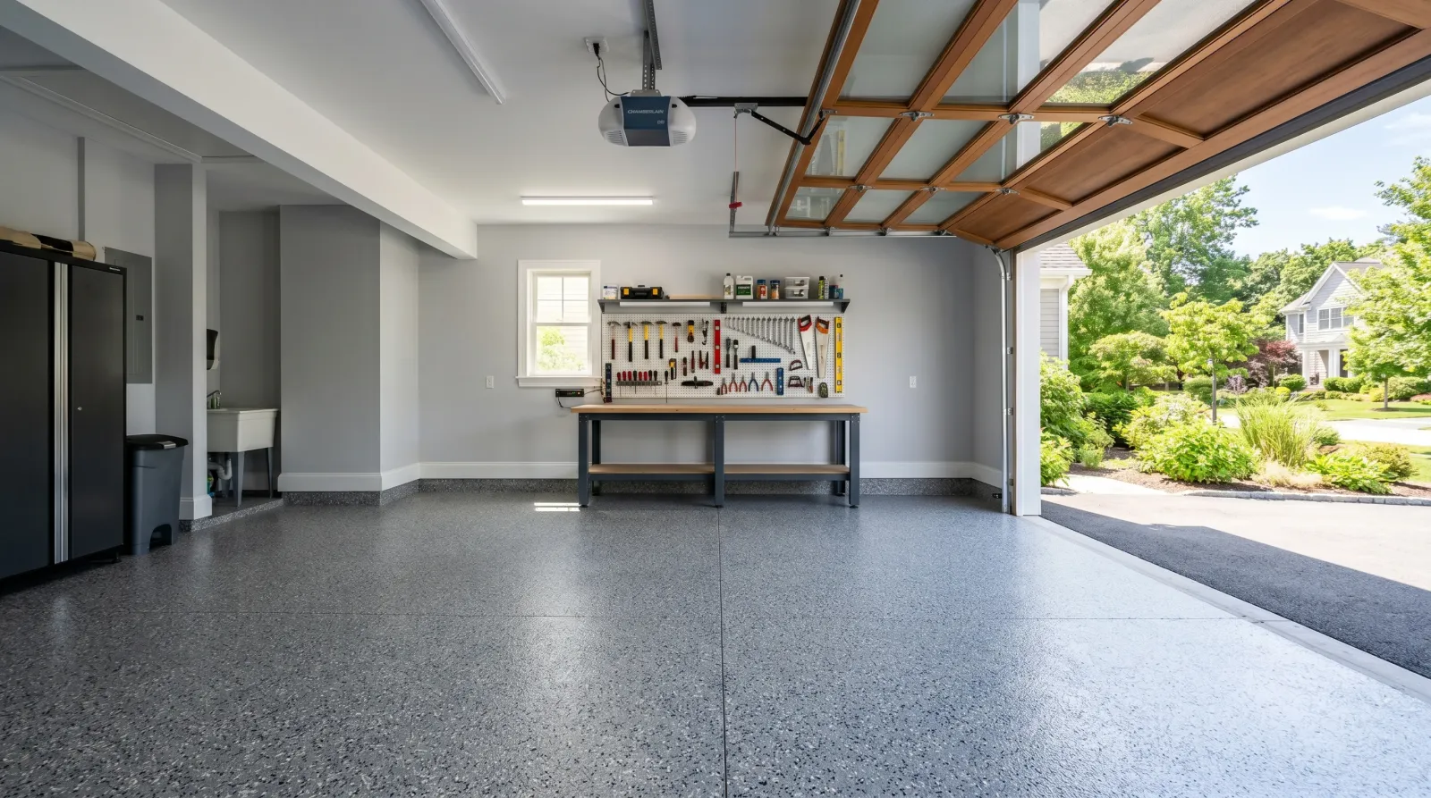 Finished garage with cured gray epoxy floor and the workbench back in place