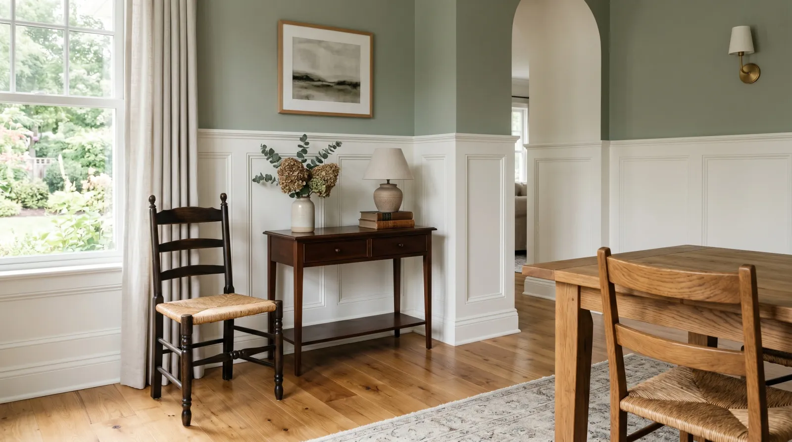 Finished room with white wainscoting below a sage wall, furniture back in place